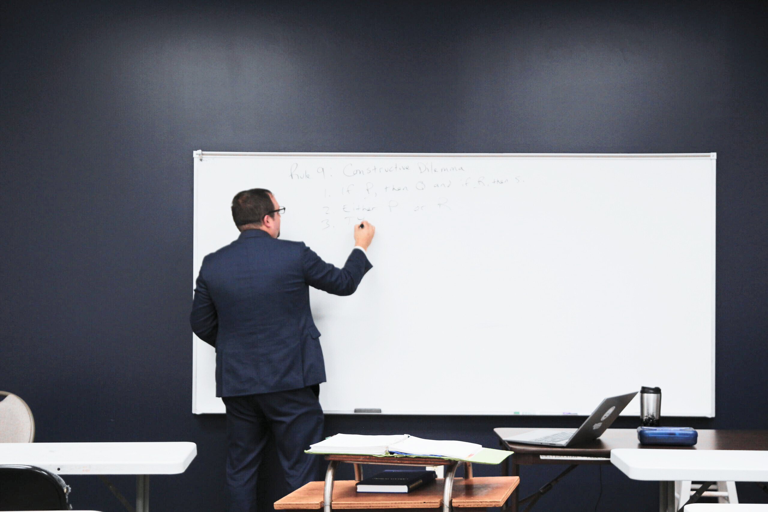 Teacher teaching logic in a Christian, classical classroom setting.